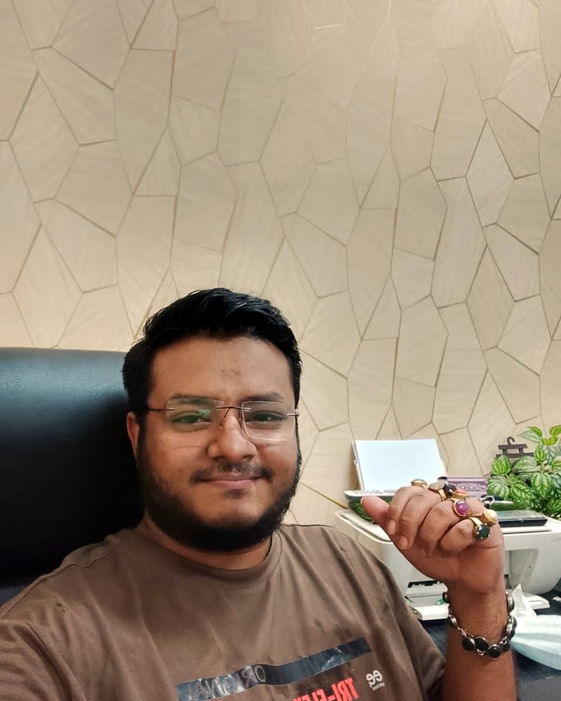 Astrologer and gemologist Musa Hossain holding astrological gemstones